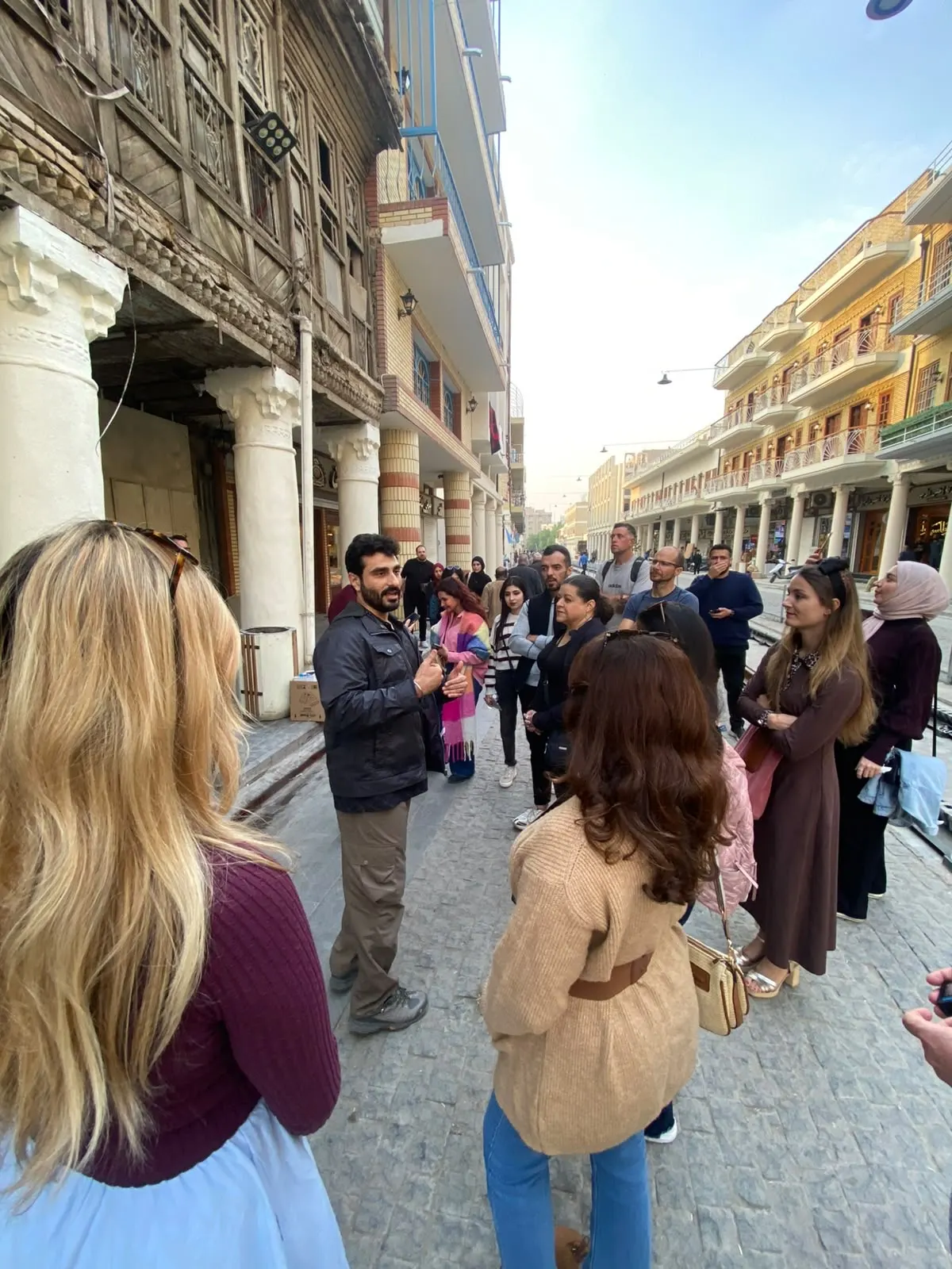 Osamah Mousa leading an international group through Old Baghdad's Rasheed Street